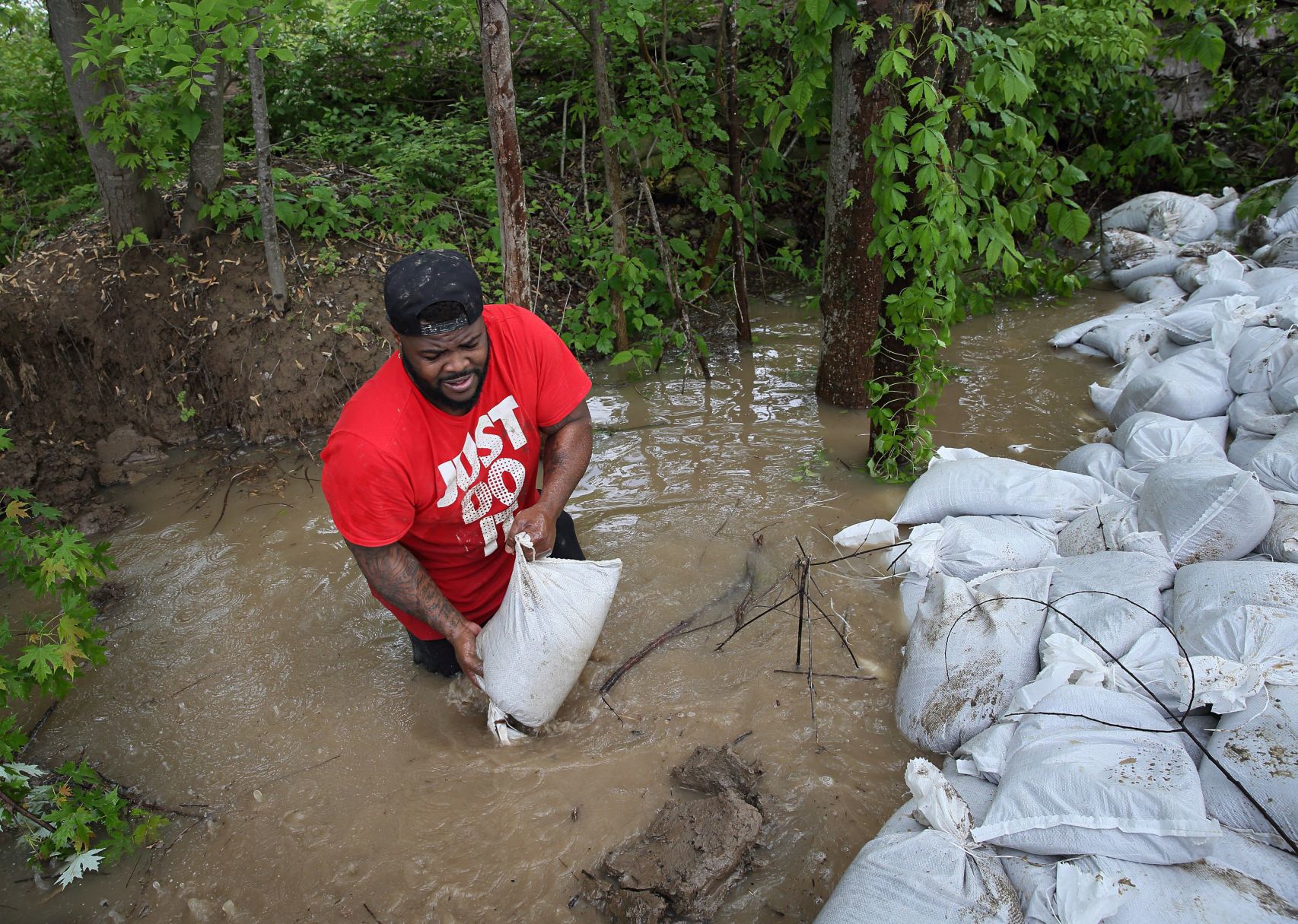 Sandbagging leaking levee in O'Fallon